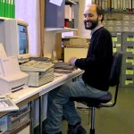 A volunteer sitting at a desktop computer.