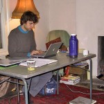 A volunteer sitting at desk using a laptop