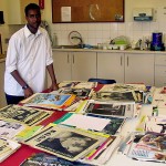 A volunteer sorting magazines and papers