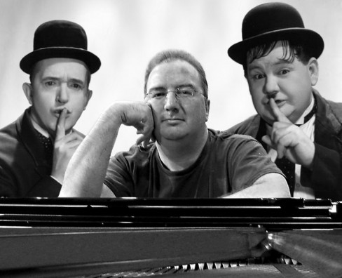 Neil Brand and his piano superimposed on a photo of Laurel and Hardy