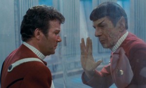 Spock dying behind glass window, watched by Kirk