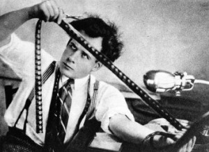 Early film editor examining length of film