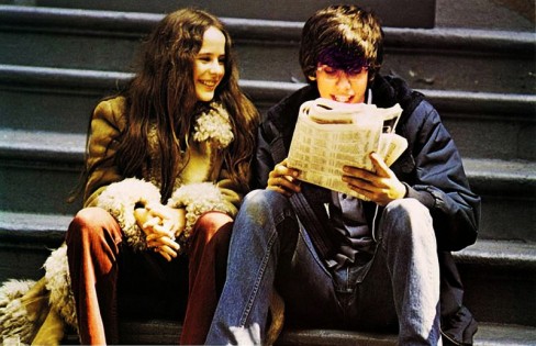 Boy and girl sitting next to each other on some steps