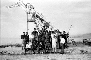Group posing in front of a rocket launcher