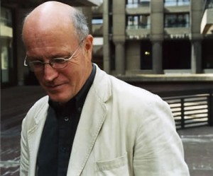 Portrait of Iain SInclair dressed in white jacket and black shirt